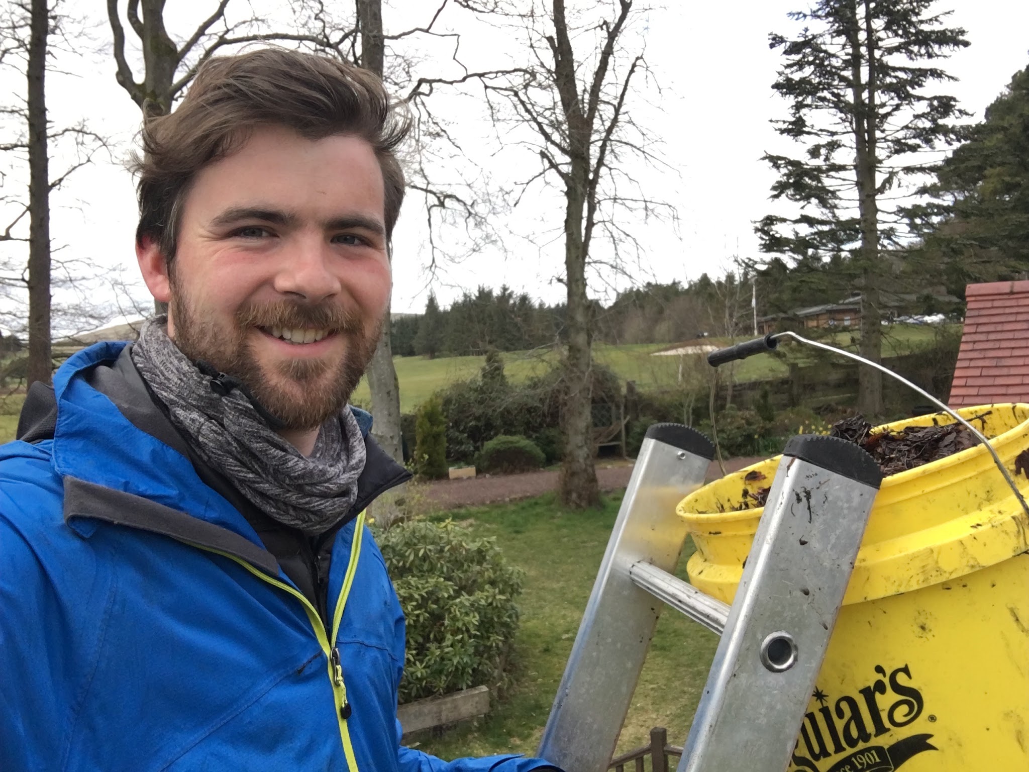 Nathaniel smiling beside his ladder and bucket